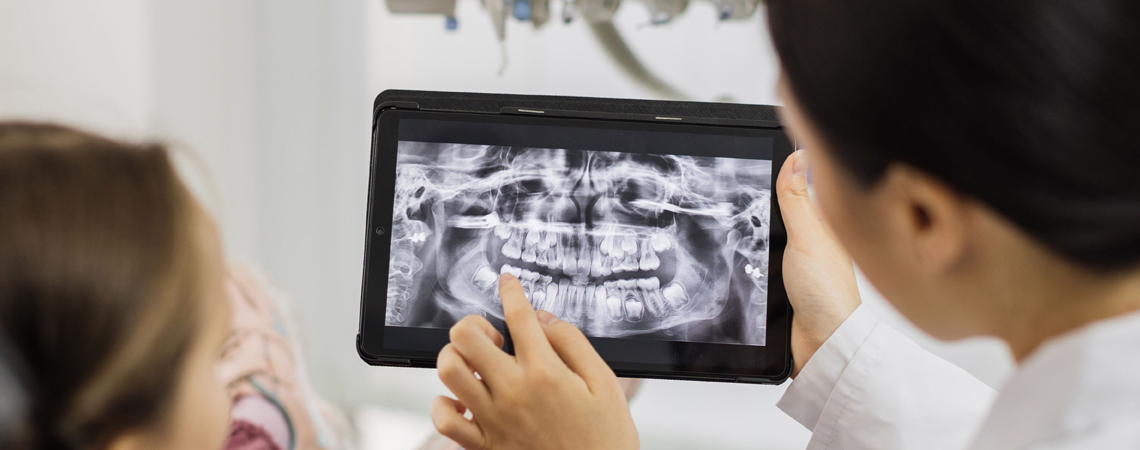 Orthodontist discussing teeth alignment and treatment with patient